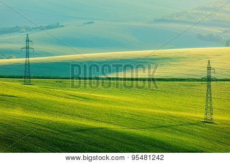 Moravian summer rolling landcsape with two power line tower. Moravia, Czech Republic