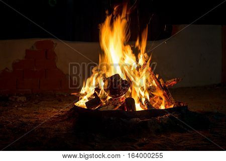 Bonfire at night flames bonfire firewood burning in the fire on dark background