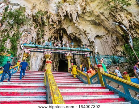 KUALA LUMPUR, MALAYSIA - JANUARY 13, 2014: Pilgrims and visitors go up on a huge ladder to Batu Caves. Kuala Lumpur, Malaysia