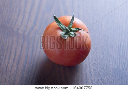 closeup of Red tomato with wooden background