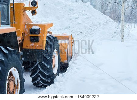 Snow clearing. Tractor clears the way after heavy snowfall.