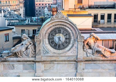 Old marble clock in milan with statues