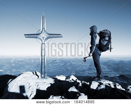 Hiker At Big Crucifix On Mountain Peak. Iron Cross At Alps Mountain Top.