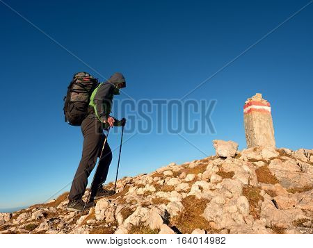 Tourist With Poles And  Backpack Walk To Mountain Peak. Last Step To Summit