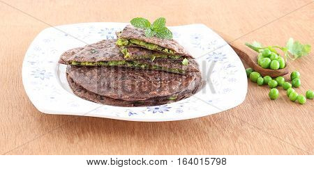 Healthy Indian food ragi paratha or bread made from finger millet flour and ground mixture of peas and other items.