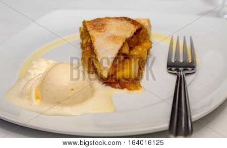Apple Pie A la Mode with fork on plate