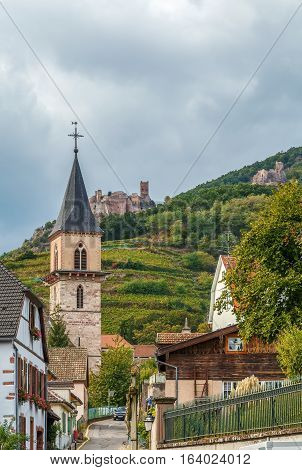 View of street in Ribeauville with castle de Saint-Ulrich on the hill Alsace France