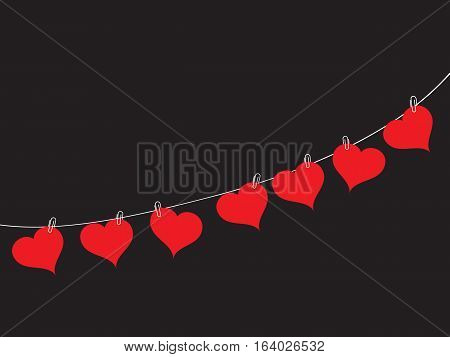 Romantic background from the red hearts hanging on a rope