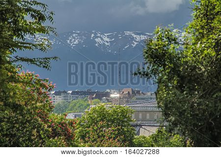 The building is near the mountains with snow