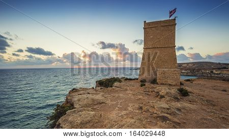 Malta - Ghajn Tuffieha watchtower at Golden Bay before sunset