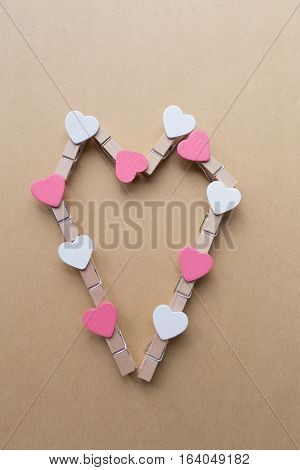Clothespins with hearts are Notepad. Background is blue paper