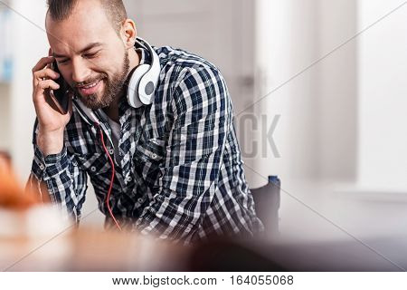 So glad to hear you. Excited physically challenged young gentleman calling someone during his break while enjoying the conversation and still wearing headphones around his neck