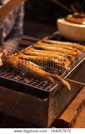 Outdoor barbecue chicken wing on the metal net grilled