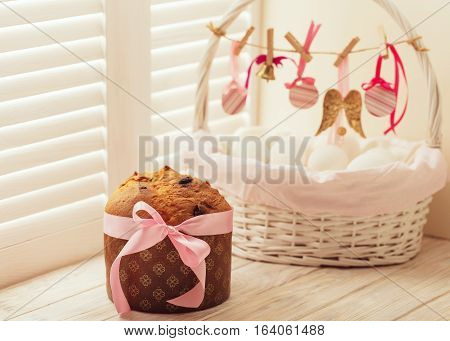 Easter cake and basket with eggs and Easter decor.