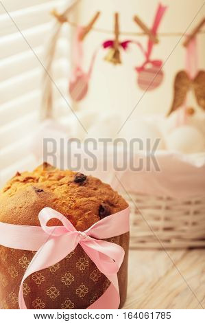 Easter cake and basket with eggs and Easter decor.