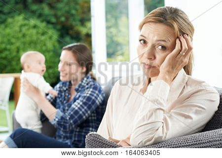 Sad Mature Woman Jealous Of Mother With Young Baby