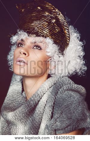 Portreit of a woman in creative head wear