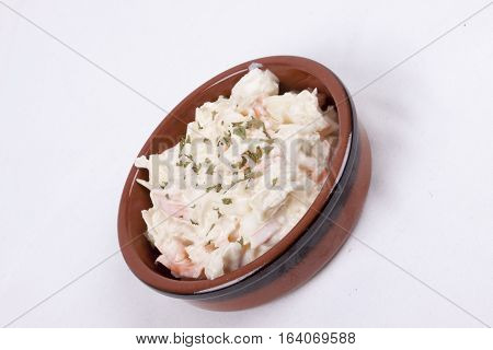 photo of pot of coleslaw isolated on a white background