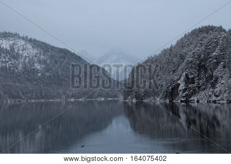 The view of Alpsee lake in winter time with mountains reflection. Germany.