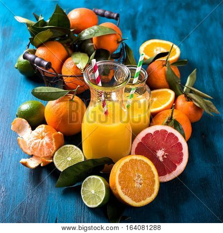 Citrus vitamin juice healthy drink with fresh fruits lime grapefruit orange tangerine. Refreshing homemade lemonade. Breakfast beverage. Square image