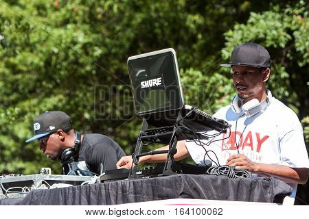 ATLANTA, GA - OCTOBER 2016: Two deejays use sophisticated electronics to enhance the audio and support the performers at the Atlanta Hip Hop Day in Woodruff Park in Atlanta GA on October 8 2016.