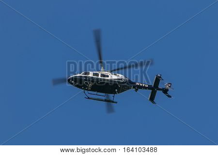 New York, June 11, 2016: A police helicopter is flying over Sheep Meadow in Central Park.