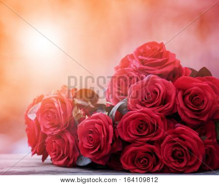 close up beautiful red roses bouguet with glowing light background for valentine day and love theme