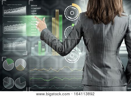 Rear view of businesswoman working with virtual panel interface