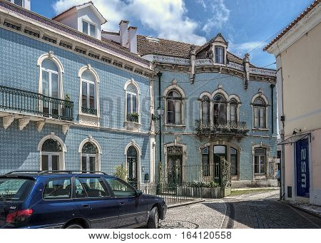 Portugal Alcobasa . Facades decorated with the famous Portuguese azulejos tiles . Roadways and sidewalks are paved with colored wild stone .