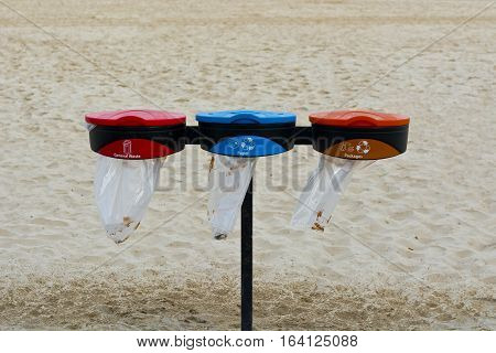 Blue and Red Recycling Containers on the Beach of Tel Aviv. Garbage Collectors Recycling Waste.