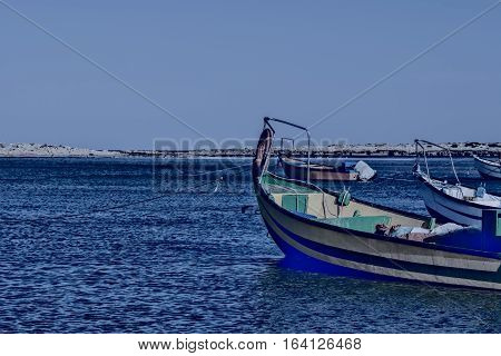 Small motor boats at the beach. Fishing Boats moored in the mediterranean sea in Israel at Night