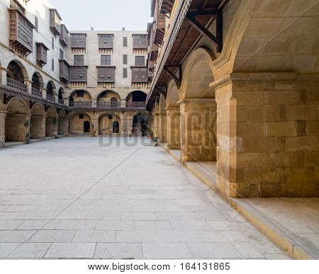 Facade of caravansary (Wikala) of Bazaraa with vaulted arcades and windows covered by interleaved wooden grids (mashrabiyya) suited in Tombakshia street Al Gamalia district Medieval Cairo Egypt