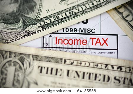 US dollar bills on tax form suggesting tax payment or audit