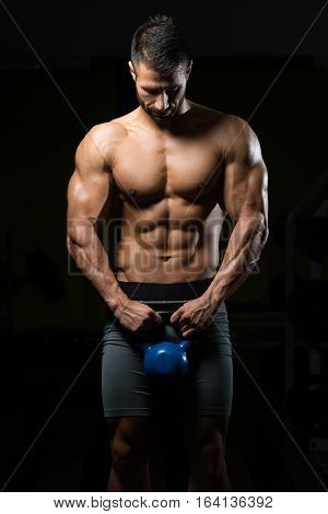 Young Man Exercising With Kettle Bell