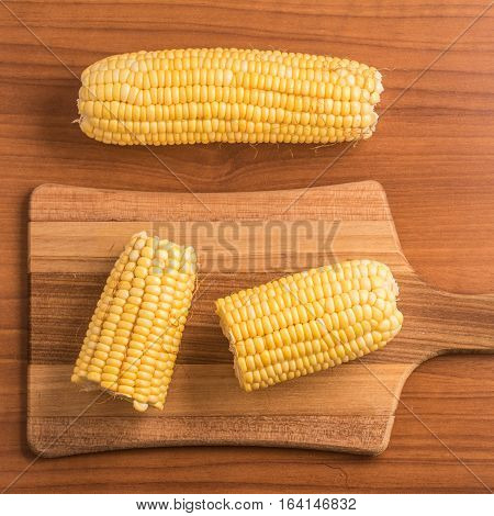 Corn Cob. Milho Verde over a wooden table