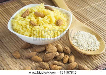 Traditional Indian Pongal, Makar Sankranti rice, nuts almonds sesame.