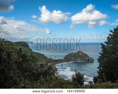 Gastelugache -  island on  coast of  Bay of Biscay belonging to  municipality of Bermeo, Basque Country.  Island is connected to  mainland by  man-made bridge that goes into  winding staircase that spans 237 degrees.