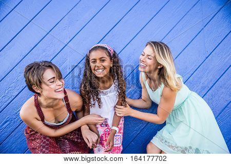 Lesbians mothers with adopted child - Happy homosexual family playing with her daughter