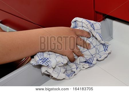 Person wipes a drawer cleanly with cleaning rags