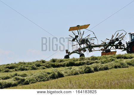 Two-wheeled swather at the hay harvest in use - Nauhaufnahme