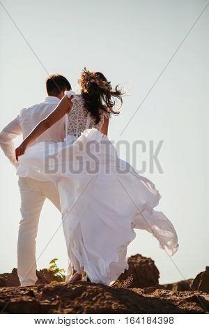 Romantic Couple Relax On Rocky Beach