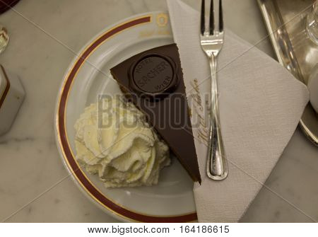 VIENNA, AUSTRIA - JANUARY 2 2016: The original Sacher Torte served with whipped cream at Hotel Sacher Hotel in Vienna