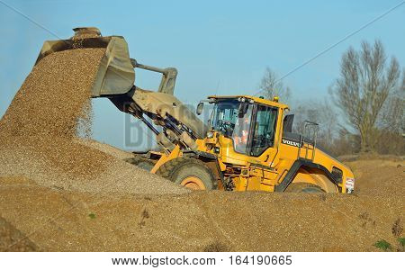 LITTLE PAXTON, CAMBRIDGESHIRE, ENGLAND -  JANUARY 05, 2017: JCB working in gravel yard.
