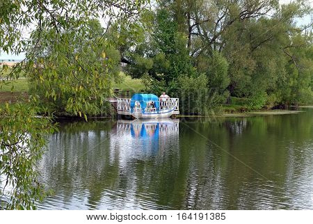 TARKHANI RUSSIA - AUGUST 28 2016: Boat with a canopy from the sun for swimming on the pond in the Lermontov estate Tarkhani