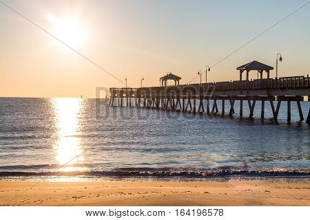 Dawn's early light on the fishing pier at Buckroe Beach in Hampton, Virginia.
