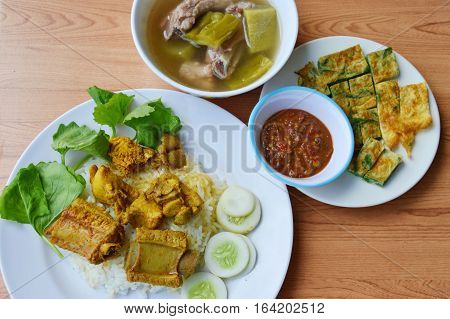 pork rib in yellow curry on rice with fried egg and soup