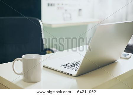 Modern and stylish laptop on a table in the office Seleted focus.