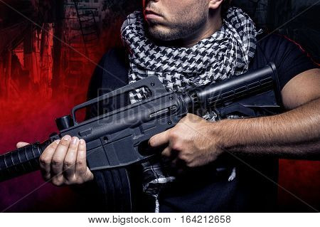 Soldier with a gun surviving in the smoky ruins of an urban warzone on fire. The military contractor or PMC is a hired militia during war.