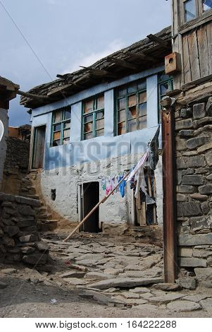 Xinaliq, Azerbaijan - August 23, 2014. Stone residential house in Xinaliq village, with linen put out to dry.