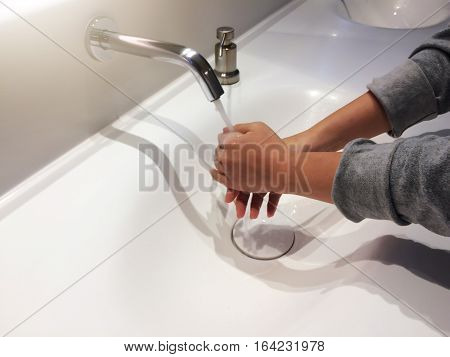 picture of the woman washing her hands in the toilets of the Department store shopping place an idea of healthy care sanitary